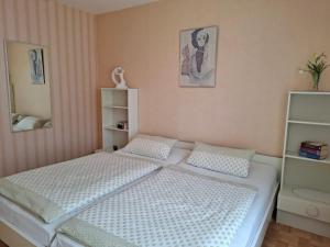 a bedroom with two twin beds and a mirror at Ferienwohnung Waltraud in Brilon