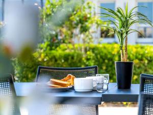 a blue table with a plate of food on it at ibis budget La Roche Sur Yon Vendespace in Mouilleron-le-Captif