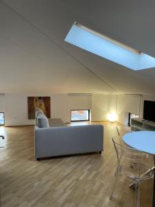 a living room with a couch and a skylight at Laffittacamere Franciacorta in Passirano