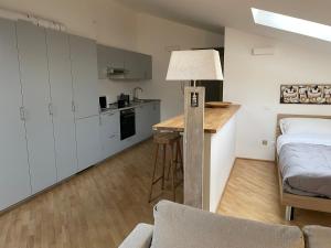 a kitchen and a living room with a bed and a table at Laffittacamere Franciacorta in Passirano