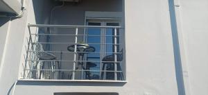 a balcony with two birds sitting on a window at Modern apartment in Thérissos +9 photos