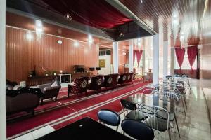 a large room with tables and chairs in a building at RedDoorz at Pasifik Hotel Sabang Aceh in Sabang