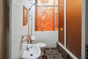 a bathroom with a sink and a toilet and a window at RedDoorz at Pasifik Hotel Sabang Aceh in Sabang +26 photos