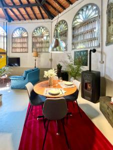 a living room with a table and a wood stove at Il Casale di Bubu in Modena