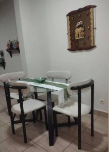 a dining room table with four chairs and a table and a table and chairsktop at La pace in Libreville