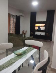 a living room with a glass table and two chairs at La pace in Libreville