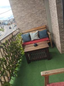 a porch with a bench on a balcony at La pace in Libreville