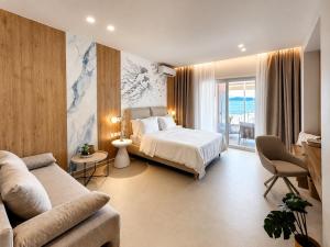 a hotel room with a bed and a couch at Ventora Suites in Nydri