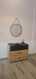 a mirror on top of a dresser in a room at Cozy Corner Heraklion in Thérissos