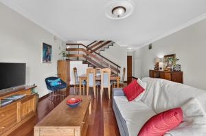 a living room with a couch and a table at Casa da Abegoaria in Caniço