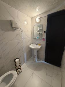 a bathroom with a toilet and a sink at Merisi - Sunset Chalet in Merisi