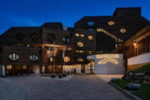 a building with a sign on the side of it at Blu Senales Active & Family Resort in Maso Corto