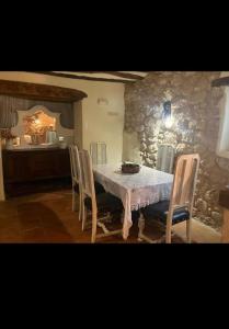 a dining room with a table and chairs at Urbasako Argizar Etxea in Larraona +8 photos