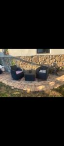 a couple of couches sitting on a brick patio at Urbasako Argizar Etxea in Larraona