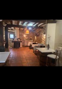a large room with tables and chairs and a fireplace at Urbasako Argizar Etxea in Larraona