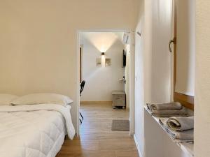 a bedroom with a bed and a hallway at Tiny House nel cuore del Monferrato in Conzano