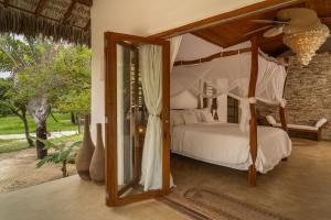 a bedroom with a canopy bed and a mirror at Villa Paz - La Villa Group in Camocim +284 photos
