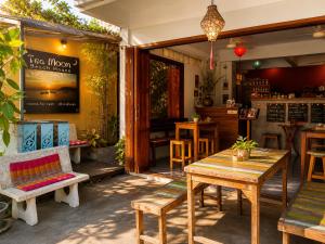 a patio with tables and chairs and a restaurant at Tea Moon Boutique Stay in Thong Sala