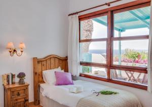 a bedroom with a bed and a large window at Apartamentos Cancajos in Los Cancajos