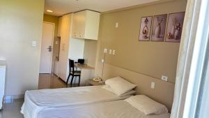 a small room with a bed and a table at Gran Lençóis Flat - Barreirinhas -MA in Barreirinhas +11 photos