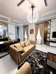 a living room with a couch and a piano at Julaz Apartment in Lagos