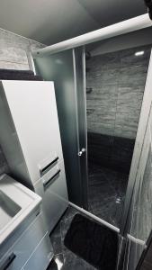 a bathroom with a shower with a glass door at Chata u Zajpta in Ústí nad Labem +9 photos