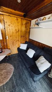 a black couch with two pillows in a room at Chata u Zajpta in Ústí nad Labem