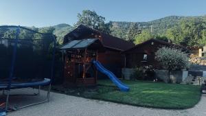 a playground with a blue slide in a yard at Chata u Zajpta in Ústí nad Labem