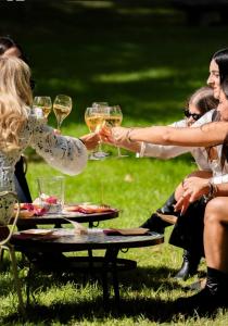 a group of people sitting around a table with wine glasses at Biondelli Boutique Winery in Cazzago San Martino +54 photos