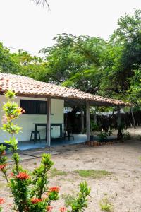 a house with a picnic table in front of it at Alto Saudade - Atins in Barreirinhas