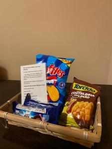 a basket filled with chips and snacks on a table at Home Blue in Caçapava