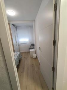a hallway with a room with a bed and a door at Alojamiento La Paz in Linares +20 photos