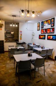 a restaurant with tables and chairs in a room at Hotel Macedonia Plaza Itagui in Medellín