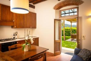 a kitchen with a table and a dining room at Agriturismo Castello Di Querceto in Lucolena in Chianti
