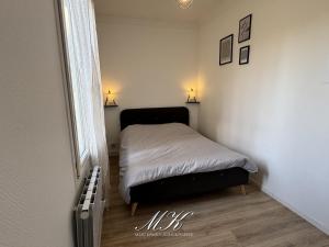 a small bedroom with a bed and a window at L'Arche in Saint-Dizier +21 photos