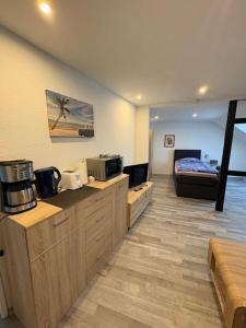 a room with a room with a bed and a kitchen at Gästehaus-City in Helmstedt