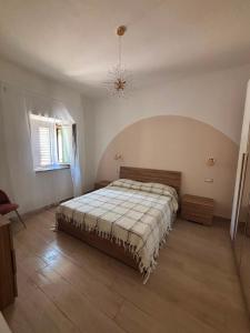 a bedroom with a bed and a chandelier at B&B Realis Terme in Montagnola