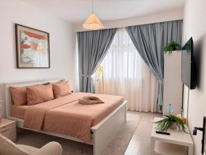 a bedroom with a bed and a television in it at Majestic Inn in Abu Dhabi