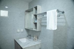 a bathroom with a sink and a white towel at The R One in Male City