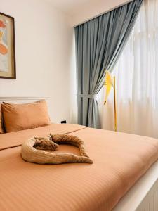 a bed with a blanket on it with a window at Majestic Inn in Abu Dhabi