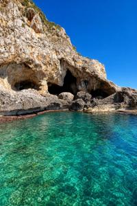 a cave in the side of a rocky cliff at charme suite delux in Terrasini