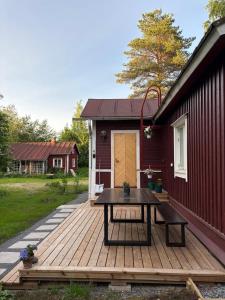 a wooden deck with a picnic table on a house at Atelier Torppa in Rovaniemi