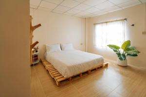 a bedroom with a bed on a wooden platform at Always Boutique Stay 2 in Kampong Huaibū