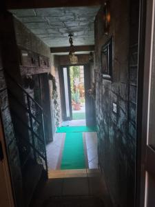 a hallway with a green floor in a house at b&b MADDIALE  +8 photos