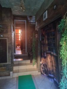a hallway of a house with a green rug on the floor at b&b MADDIALE 