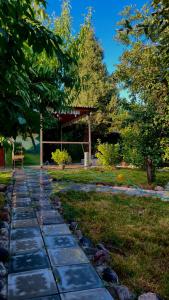 a stone path in a garden with a gazebo at Ners House in Garni