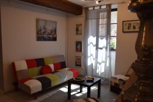 a living room with a couch and a window at La Maison bleue in Rossillon