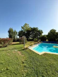 a small swimming pool in a yard with grass at La Prairie 65 in Lafitole