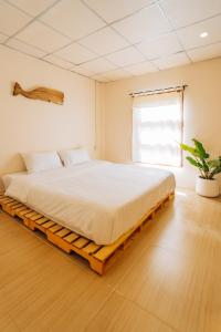 a bedroom with a large bed in a room at Always Boutique Stay 2 in Kampong Huaibū