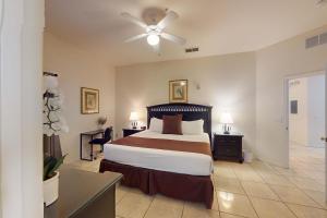 a bedroom with a bed and a ceiling fan at Exclusive 3BR villa: pools near Disney magic in Kissimmee +107 photos